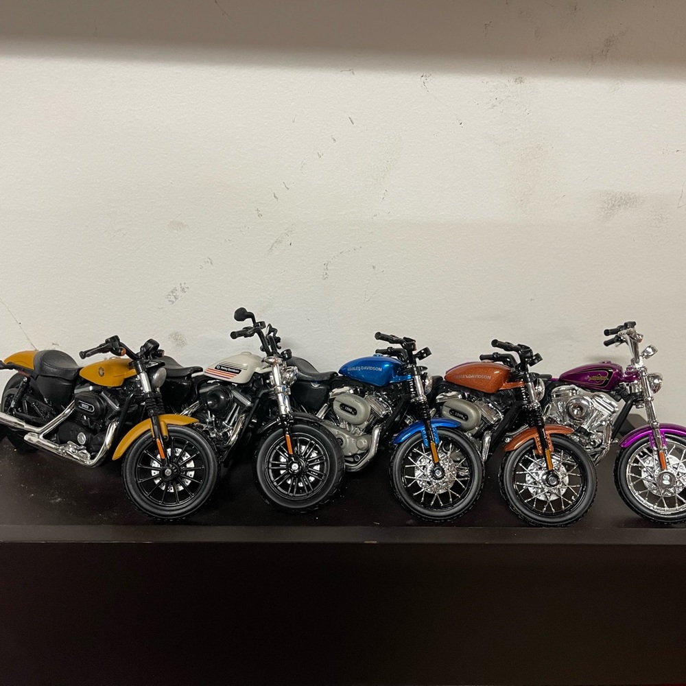 24 Harley Davidson diecast motorcycles.